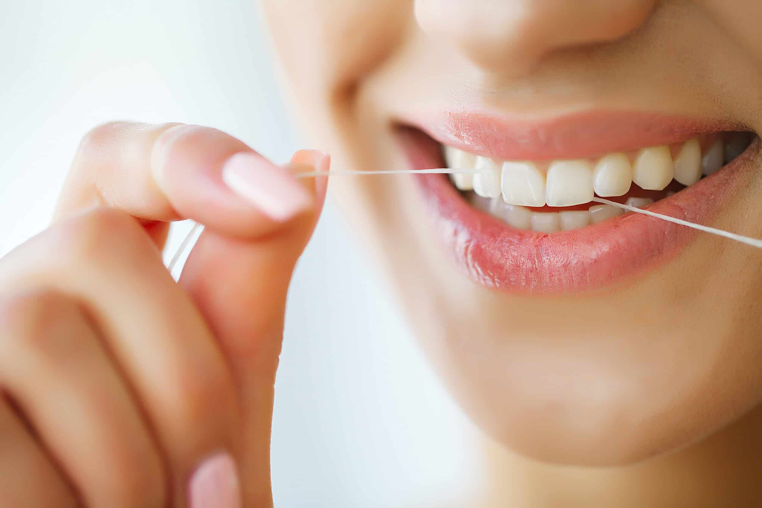 dental-care-woman-with-beautiful-smile-using-floss-for-teeth-image-scaled
